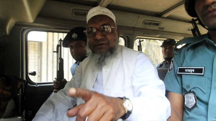 File photo of Bangladesh's Jamaat-e-Islami leader Abdul Quader Mollah gesturing as he talks from a police van in Dhaka