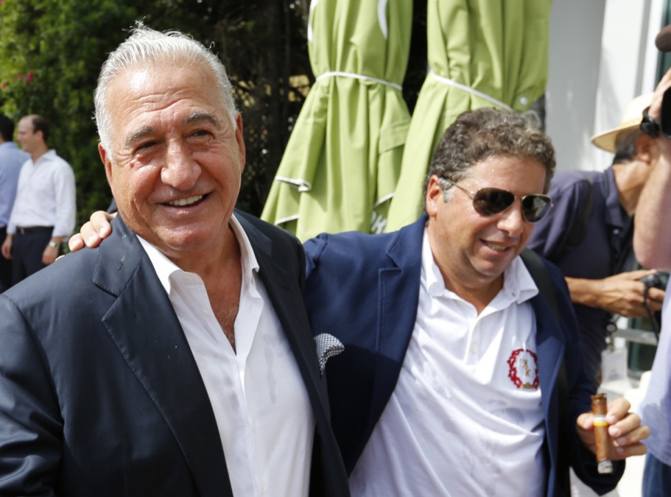 Joe Nakash and Eli Gindi, with the business group VM South Beach, react after winning an auction with their bid of $41.5 million for a mansion once owned by Italian fashion designer Gianni Versace, in Miami Beach