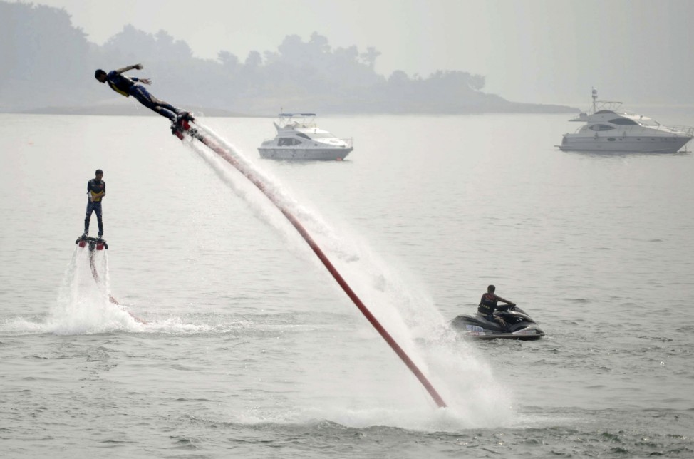 People riding on water-powered jet-boards perform on Qiandaohu Lake in Hangzhou