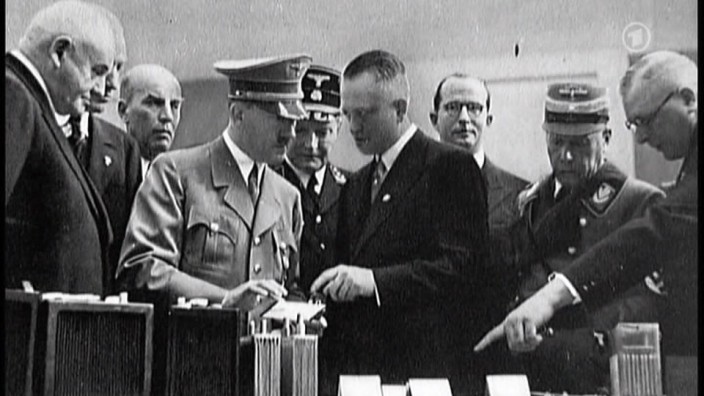 Industriellenfamilie Quandt: Adolf Hitler lässt sich 1938 auf einer Messe neueste Entwicklungen des Batteriekonzerns AFA zeigen. Die Firma gehörte zum Reich von Günther Quandt (l.).