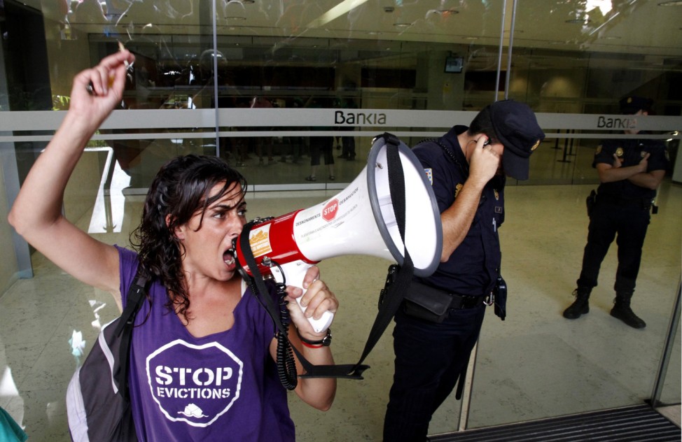 A member of the Mortgage Victims' Platform shouts as other activists occupy Bankia's central branch in Valencia
