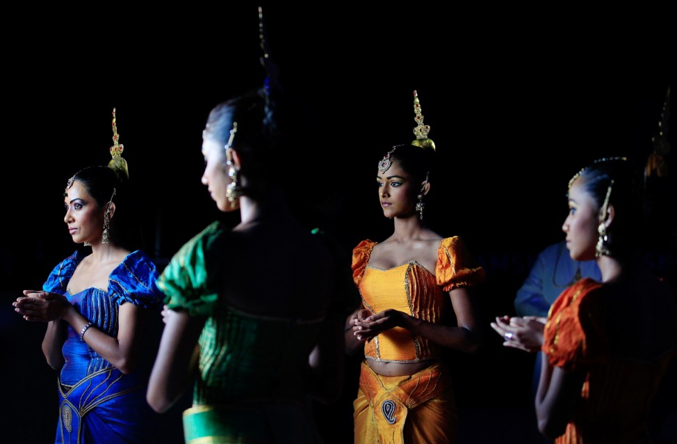 Traditional dancers wait for guests during the Kramaski factory's 20th anniversary celebrations in Katunayake