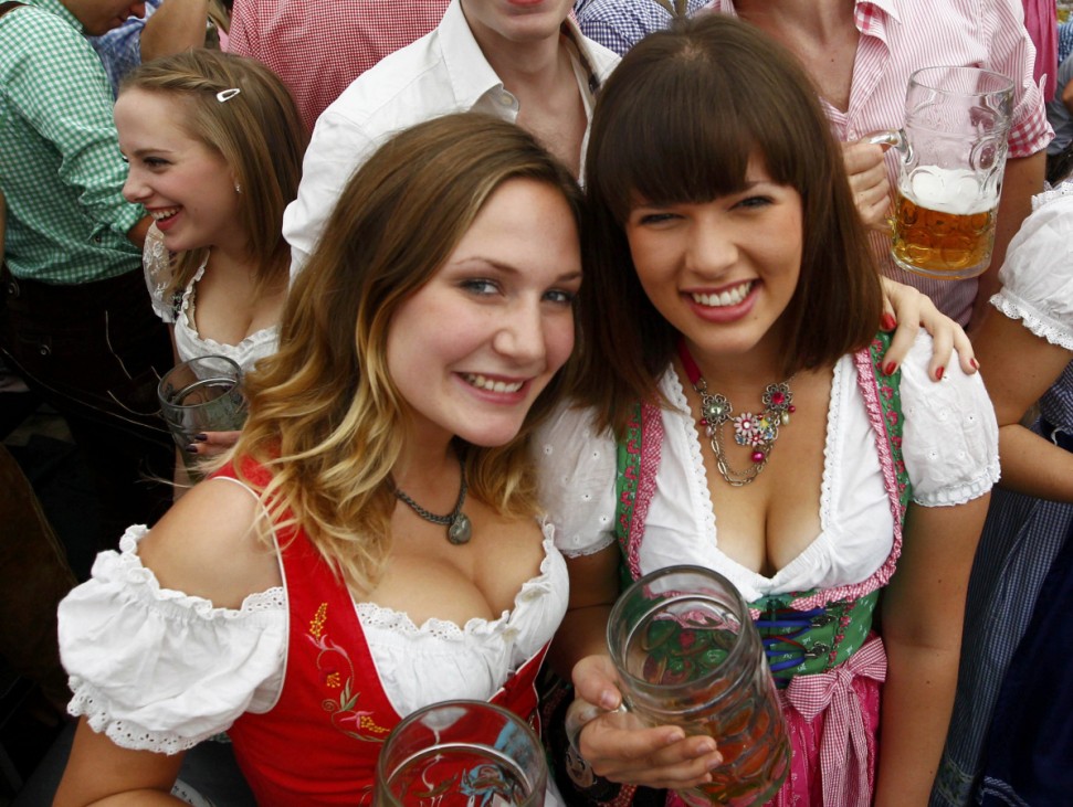 Women wearing traditional Bavarian Dirndl dresses pose during opening day of 180th Oktoberfest in Munich