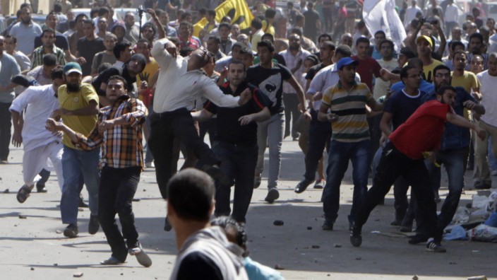 Supporters of deposed President Mursi and Muslim Brotherhood clash with anti-Mursi protesters during march in Shubra street in Cairo