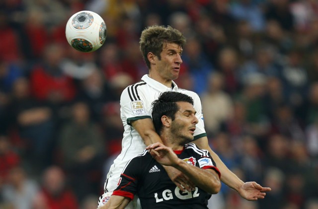 Spahic of Bayer Leverkusen challenges Bayern Munich's Mueller during their German first division Bundesliga soccer match in Leverkusen