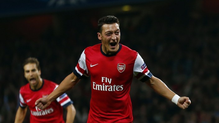 Arsenal's Ozil celebrates after scoring a goal against Napoli during their Champions League soccer match at the Emirates stadium in London
