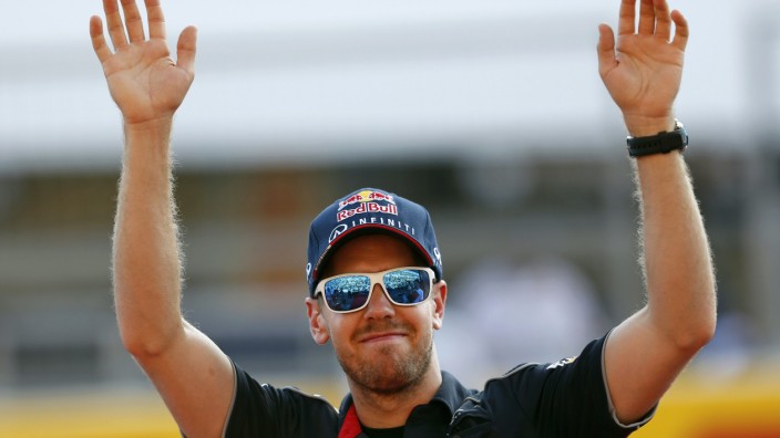 Red Bull Formula One driver Vettel of Germany waves to fans at the Suzuka circuit