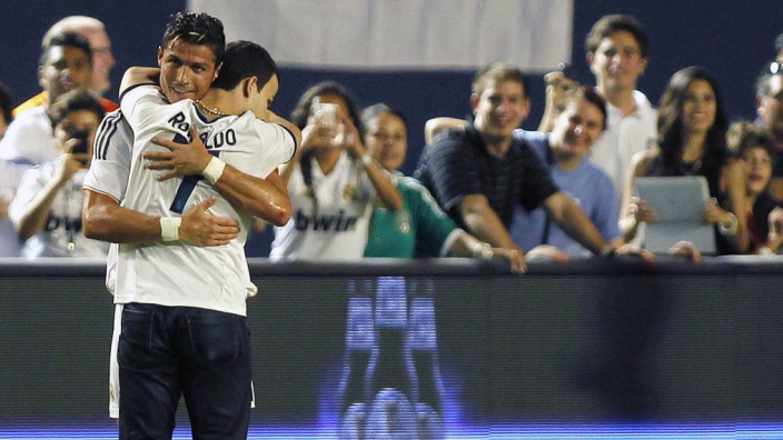 Real Madrid's Ronaldo hugs a fan who entered the pitch during match against Chelsea in Miami Gardens