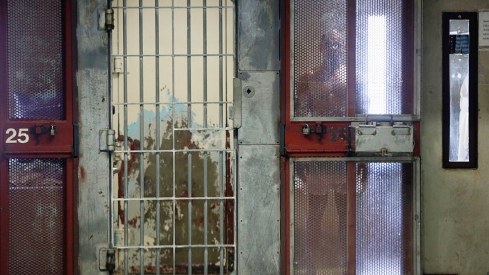 An inmate looks out from his cell in the Secure Housing Unit at Corcoran State Prison in California