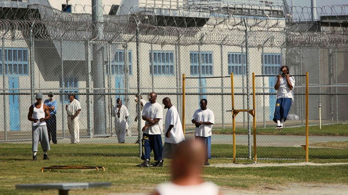 Inmates workout in the yard at Corcoran State Prison in California