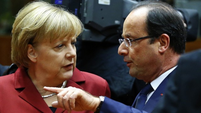 Germany's Chancellor Merkel talks with France's President Hollande arrive at a European Union leaders summit in Brussels