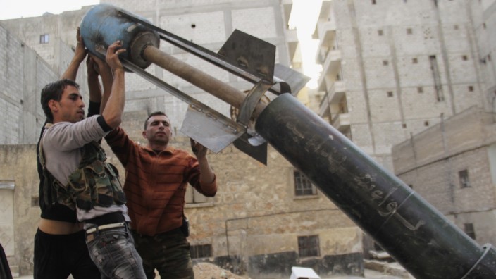 Free Syrian Army fighters prepare to fire home-made rocket towards forces loyal to President Al-Assad in Ashrafieh, Aleppo