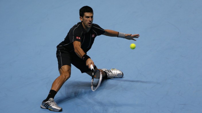 Novak Djokovic of Serbia hits a return during his men's singles tennis match against Juan Martin del Potro of Argentina at the ATP World Tour Finals at the O2 Arena in London