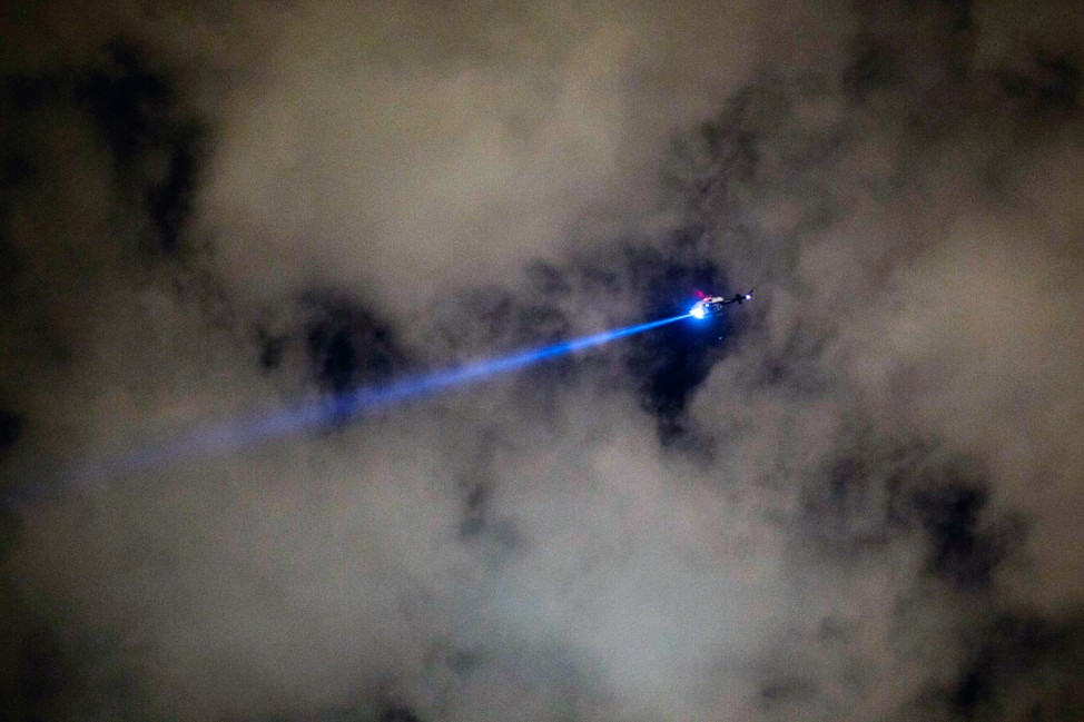 A New York Police Department helicopter flies over the scene of a multiple shooting crime scene on Maujer Street in the Brooklyn borough of New York