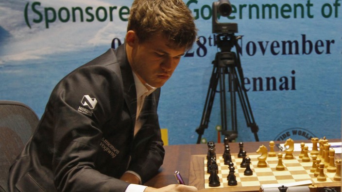 Norway's Carlsen writes down move against India's Anand during FIDE World Chess Championship in Chennai