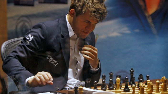 Norway's Carlsen writes down his move against India's Anand during the FIDE World Chess Championship in Chennai