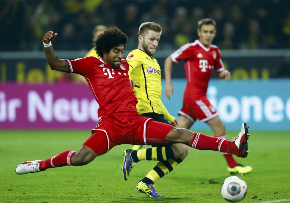 Borussia Dortmund's Blaszczykowski fights for the ball with Bayern Munich's Dante during their German first disvison Bundesliga soccer match in Dortmund
