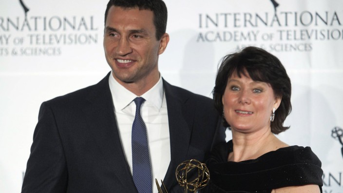 Boxer Klitschko of Ukraine and CEO of RTL TV Schaeferkordt of Germany pose for photographers with her Directorate Award backstage during the 41st International Emmy Awards in New York