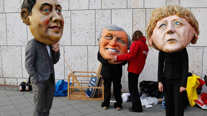 Environmental activists of 'Campact!', wear masks during protest outside coalition talks at CDU party headquarters in Berlin