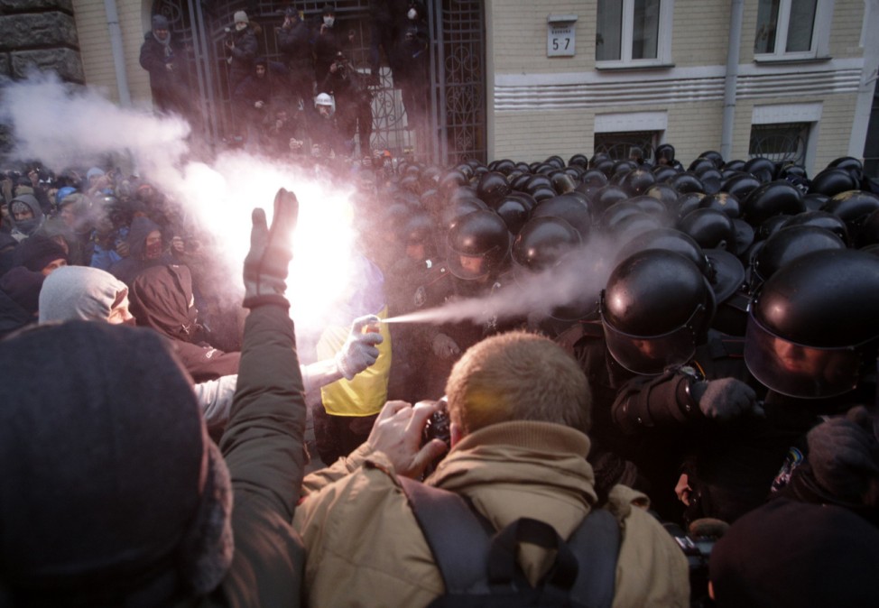 Protesters try to break through police lines near the presidential administration building during a rally held by supporters of EU integration in Kiev