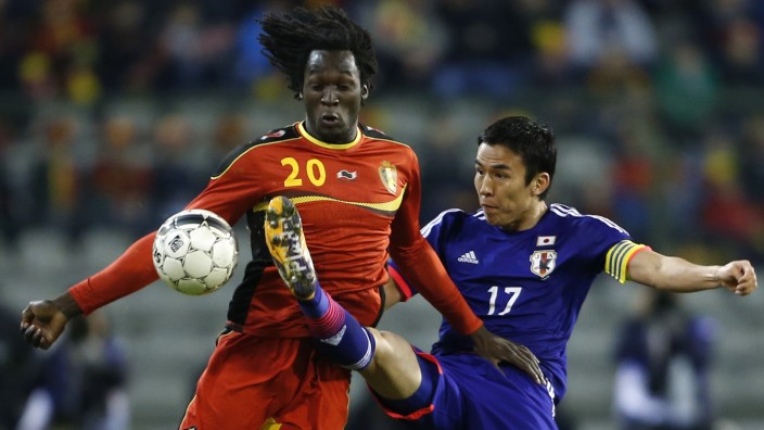 Belgium's Lukaku fights for the ball with Japan's Hasebe during their international friendly soccer match at King Baudouin stadium in Brussels