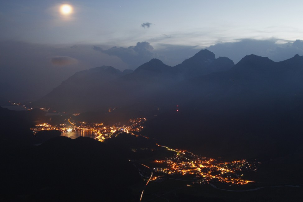 A night view taken from the Muottas Muragl mountain shows the Swiss mountain resort of St. Moritz and the village of Celerina