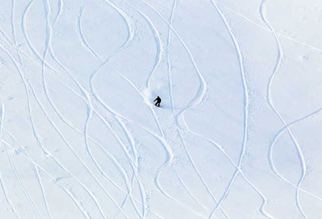 A snowboarder descends through fresh powder on Whistler Mountain in Whistler