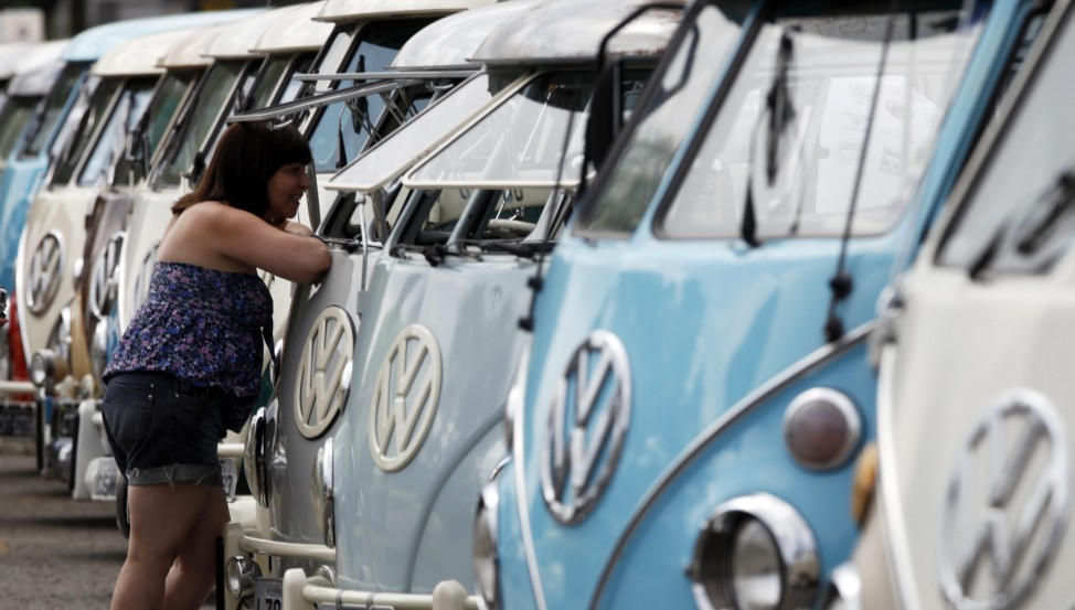 A visitor looks at Volkswagen Kombi minibus models during a Kombi fan club meeting in Sao Bernardo do Campo