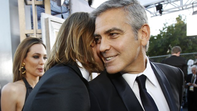 Actors Pitt and Clooney greet each other as actress Jolie looks on, upon arrival at the 18th annual Screen Actors Guild Awards in Los Angeles, California