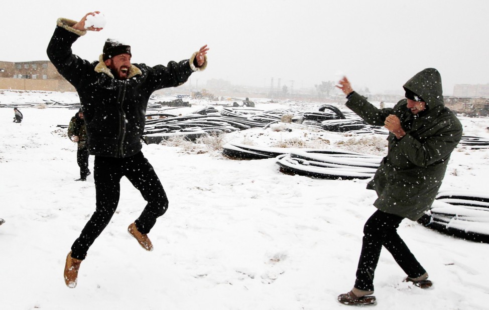 Free Syrian Army fighters play with snow in Raqqa