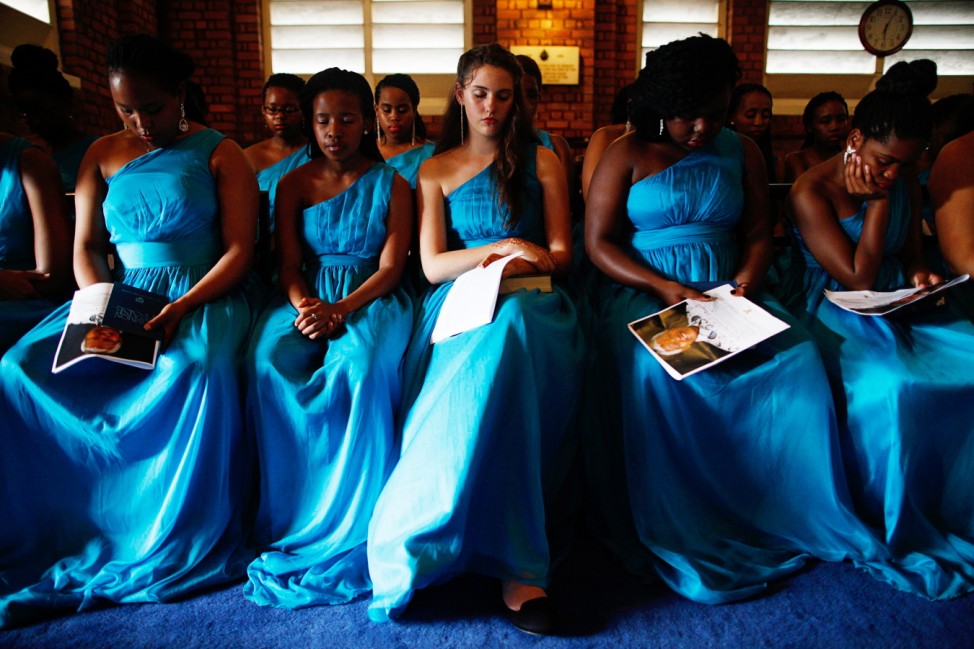 St Mary's Church choir girls pray at a memorial service for former South African President Mandela in Singapore