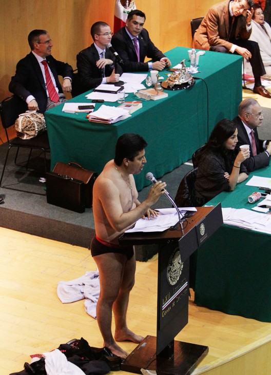Antonio Garcia of the PRD addresses the audience after stripping down to his underwear during his speech in Mexico City