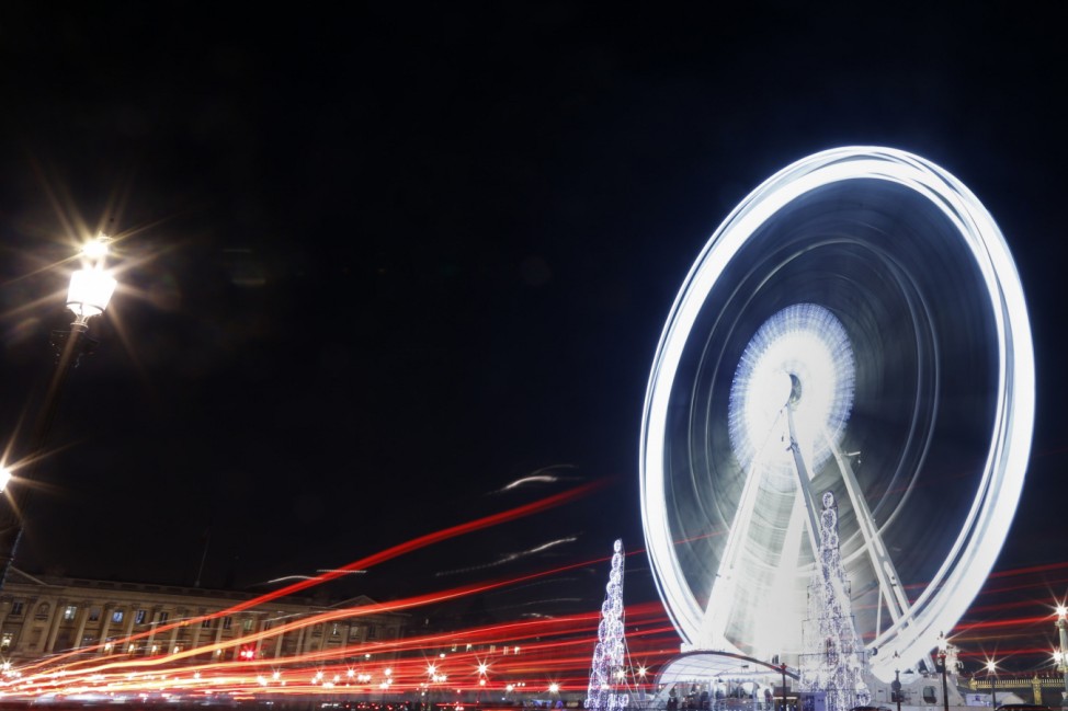 A giant Ferris wheel lights up the night sky for the Christmas holiday season on the Place de la Concorde square in Paris
