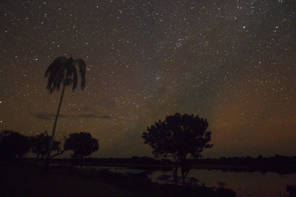 A night view of the Sao Raimundo do Jaraua community along the edge of a tributary of the Solimoes river in the Amazon basin