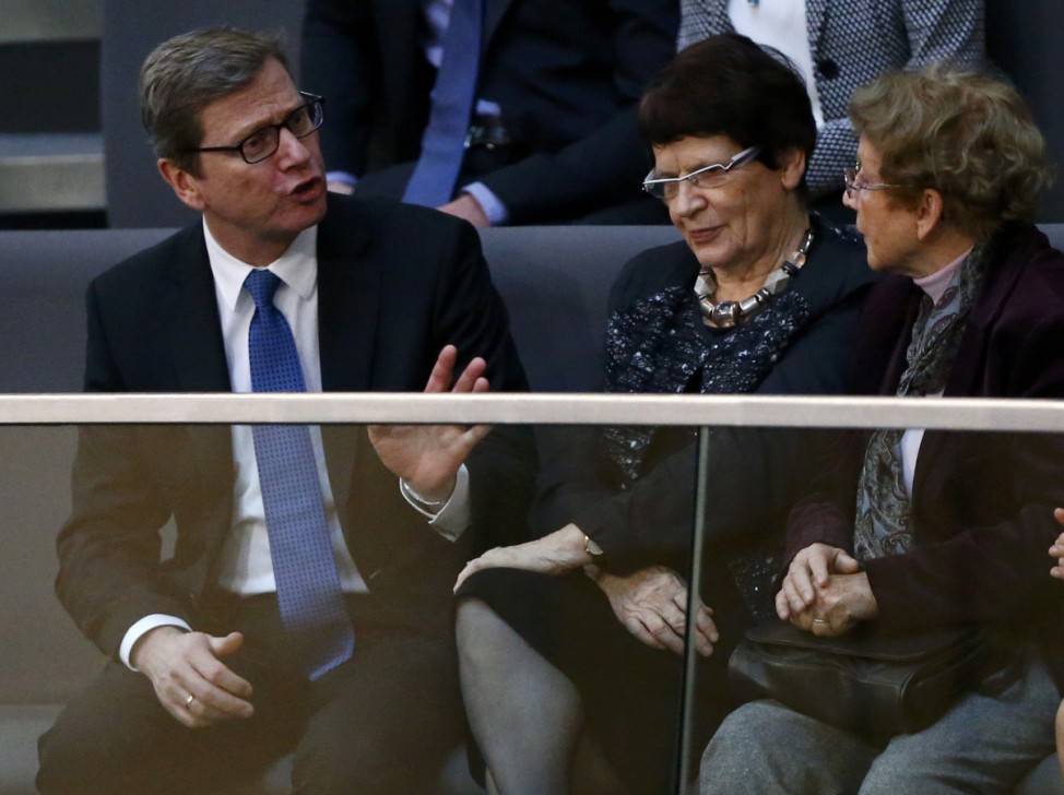 Former German foreign minister Westerwelle talks to former Bundestag President Suessmuth and Herlind Kasner during Bundestag meeting to elect Chancellor in Berlin