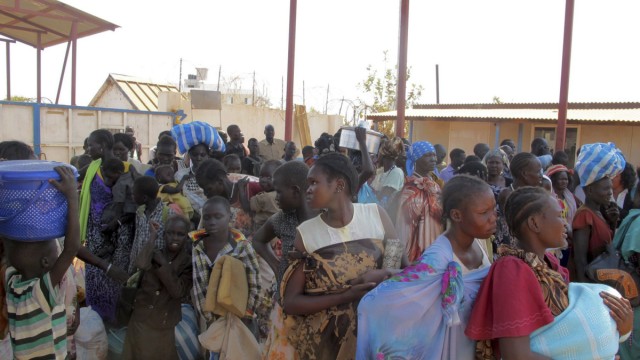 Displaced Sudanese civilians arrive at the United Nations Mission in the Republic of South Sudan compound on the outskirts of the capital Juba
