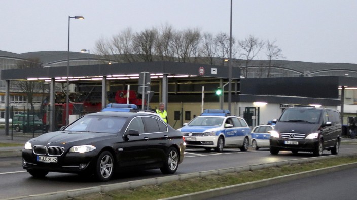 A convoy of cars which are belived to carry former oil tycoon Khodorkovsky is escorted by German police as they leave the Schoenefeld airport in Berlin