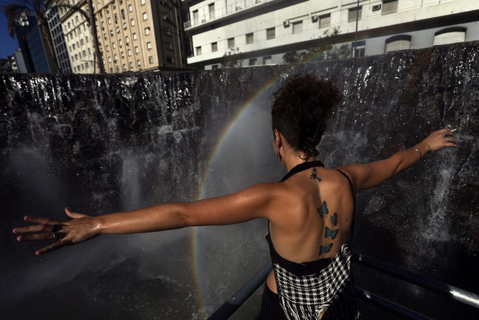 A demonstrator reacts at a fountain that emulates the Iguazu Falls during a rally commemorating the 12th anniversary of the social and economic crisis that led to Argentine former President Fernando De la Rua's resignation, in Buenos Aires