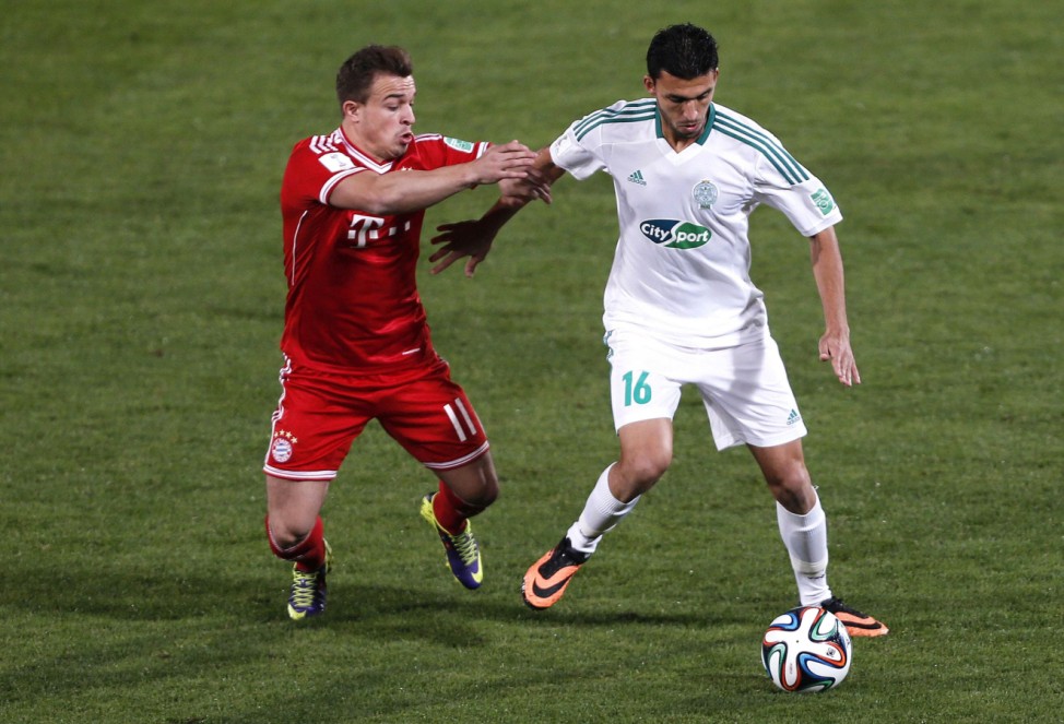 Mohamed Oulhaj of Morocco's Raja Casablanca fights for the ball with Xherdan Shaqiri of Germany's Bayern Munich during their 2013 FIFA Club World Cup final soccer match at Marrakech stadium