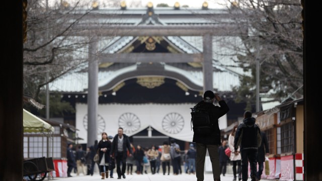 Visitor takes pictures at Yasukuni shrine in Tokyo