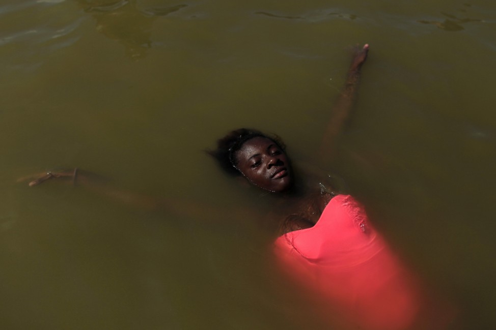 A girl relaxes in the Piscinao de Ramos artificial lake in Rio de Janeiro