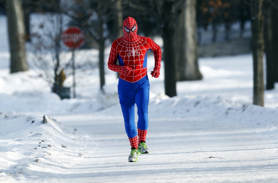 A man jogs around Lake Harriet in south Minneapolis in a Spiderman wind suit