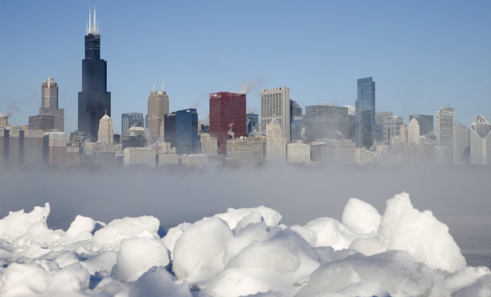 Chicago skyline is seen beyond the arctic sea smoke rising off Lake Michigan in Chicago