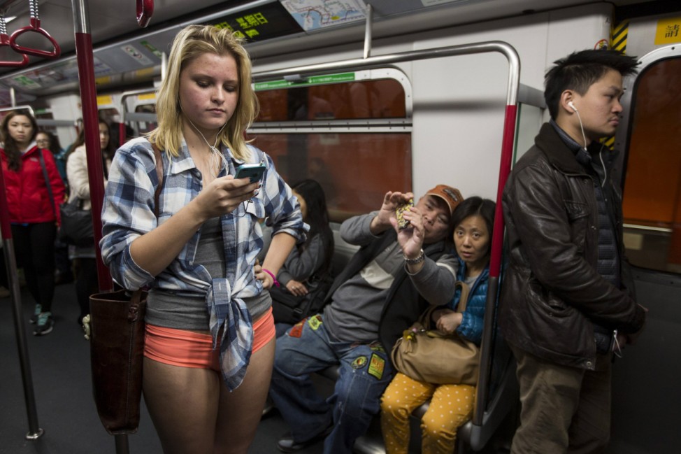 A woman takes part in the annual 'No Pants Subway Ride' on a Mass Transit Railway (MTR) train in Hong Kong