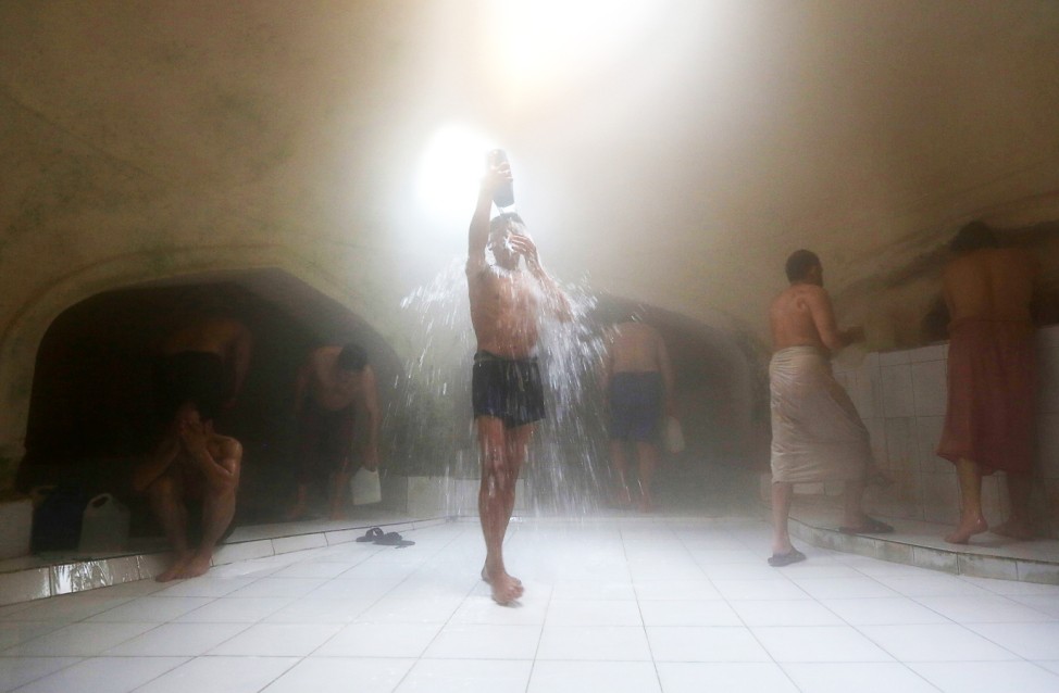 Afghan men wash themselves at a bathhouse in Kabul