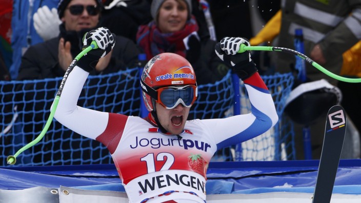 Kueng of Switzerland reacts after his run during men's World Cup downhill race in Wengen