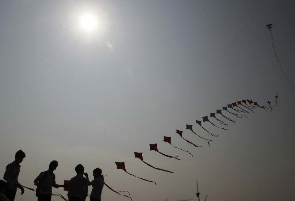 People fly their kites during the annual Khmer kite flying festival in Phnom Penh