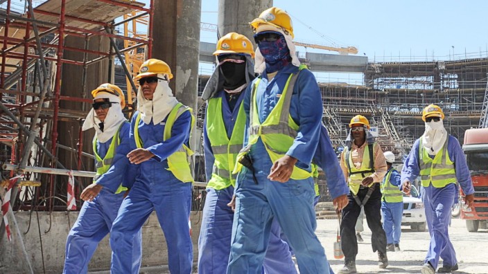 Foreign laborers work in Doha