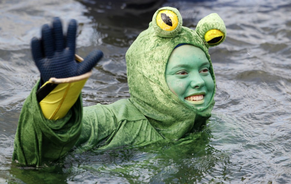 A swimmer wearing a costume swims in the cold waters of the river Danube in Neuburg an der Donau