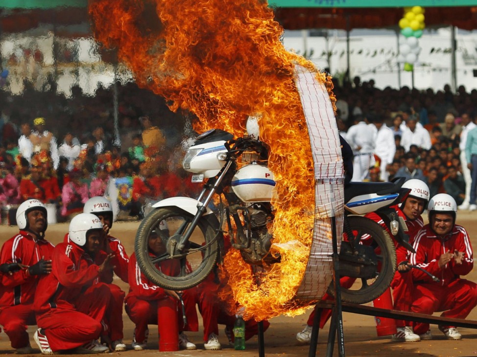 A member of the Gujarat police jumps through a ring of fire during Republic Day celebrations at Himmatnagar